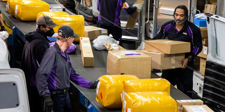 Workers sort packages at a FedEx Express facility on Cyber Monday in Garden City, N.Y., on Nov. 28, 2022.