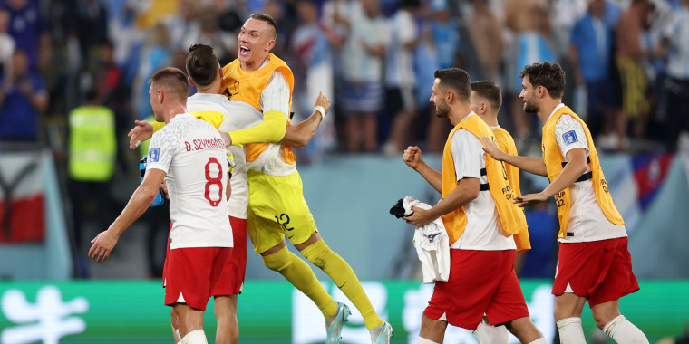 Poland players celebrate after their side's qualification to the knockout stages during the FIFA World Cup Qatar 2022 Group C match between Poland and Argentina at Stadium 974 on November 30, 2022 in Doha, Qatar.