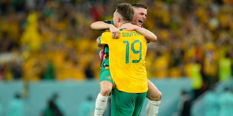 Australia's Harry Souttar celebrates with a teammate at the end of the World Cup group D soccer match between Australia and Denmark at the Al Janoub Stadium in Al Wakrah, Qatar