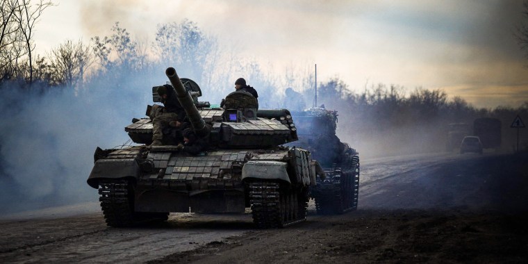 Ukrainian tank rolls along a road in Bakhmut, in the country's east. 