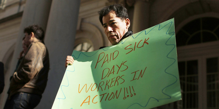 A man holds a sign at a rally in front of City Hall to show support for a paid sick leave bill, a day after New York City Council Speaker Christine Quinn announced that lawmakers and advocates reached a deal on the legislation March 29, 2013 in New York City. The bill would force businesses with 20 or more employees to provide five paid sick days a year beginning in April 2014. New York Mayor Michael Bloomberg, who opposes the bill, said he would veto it if it comes to his desk.