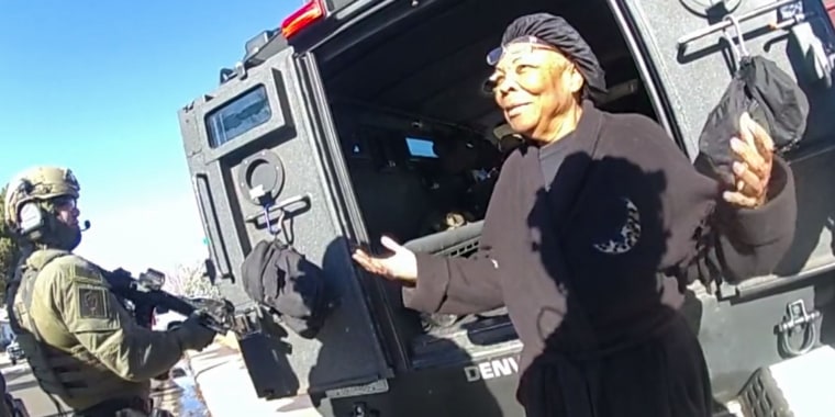 Ruby Johnson talks with Denver SWAT officers on Jan. 4, 2022, outside her home in Denver's Montbello neighborhood.