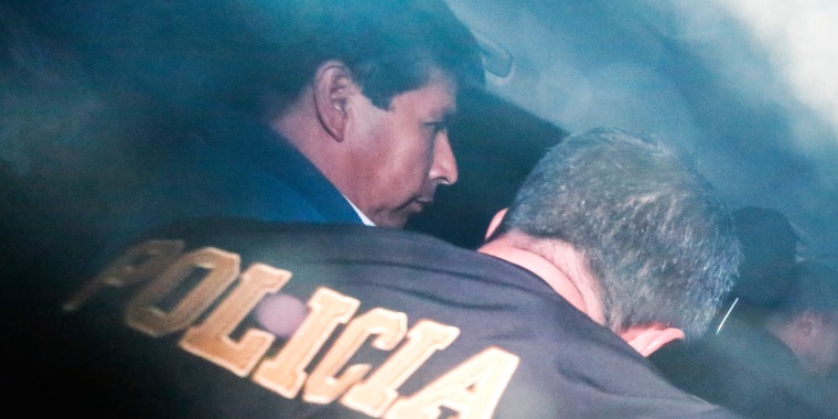 Castillo is escorted by police after being ousted in Lima on Wednesday.