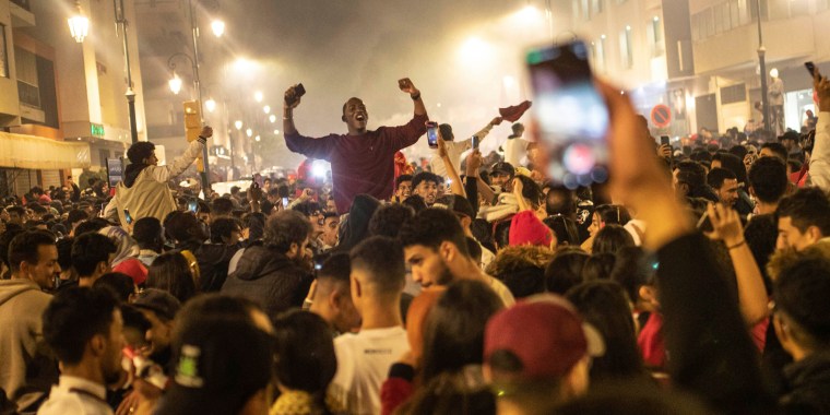 Moroccans celebrate their win over Spain in a World Cup soccer match, in Rabat, Morocco