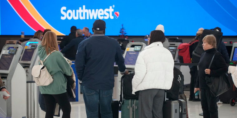 Travelers queue up at the check-in counters for Southwest Airlines in Denver International Airport