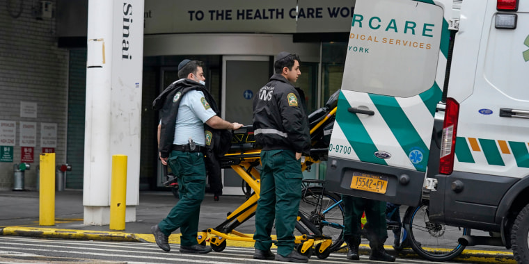 Emergency personnel load an ambulance in front of Mount Sinai Hospital in New York on Jan. 12, 2023. 