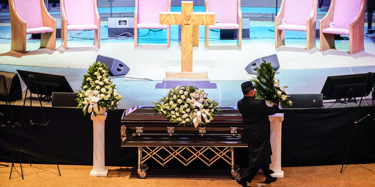 Image: A man arranges flowers around Tyre Nichols' casket at Mississippi Boulevard Christian Church in Memphis, Tenn., on Feb. 1, 2023.