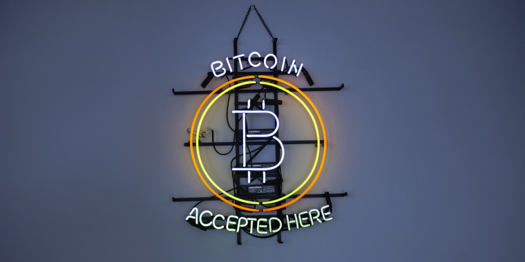 A neon sign indicating that Bitcoin is accepted.
