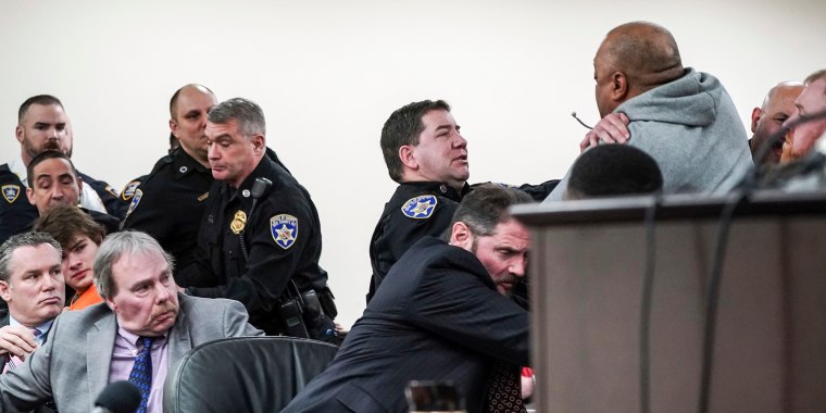 Image: Assistant district attorney Gary Hackbush, center, helps deputies restrain a man who lunged towards the Payton Gendron during the sentencing of Tops gunman Payton Gendron at Erie County Court in Buffalo, N.Y., on Feb 15, 2023.