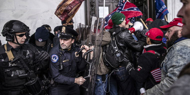 Demonstrators clash with U.S. Capitol police officers while trying to enter the Capitol building during a protest on Jan. 6, 2021.