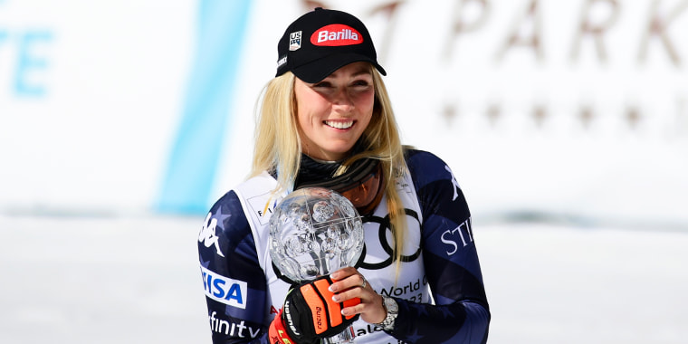 Mikaela Shiffrin hold the crystal globe while she celebrates her Women's Slalom victory