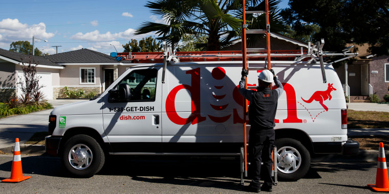 A Dish Network Corp. field service specialist carries a ladder after installing a satellite television system at a residence in Paramount, Calif.