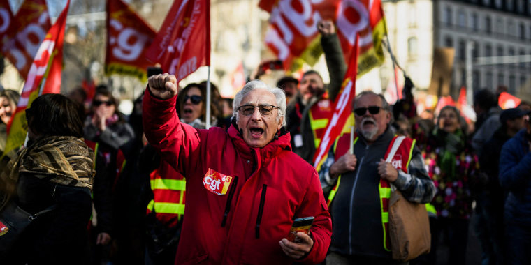 People protest after the government pushed a pensions reform through parliament without a vote in Clermont-Ferrand, France, on March 28, 2023.