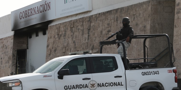 Police stand guard outside a migrant detention center in Ciudad Juarez, Mexico
