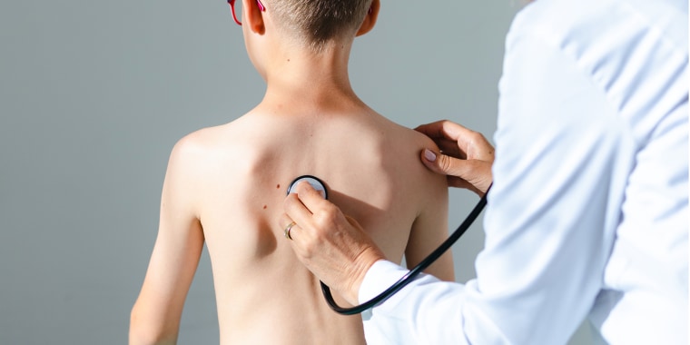 Doctor checking boy's lungs With a stethoscope