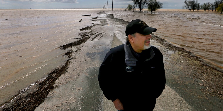 Mark Grewel on a farm road that was flooded in Lemoore, Calif