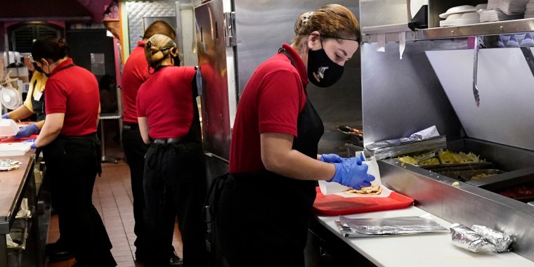 Employees work at a restaurant in Chicago