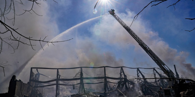 Firefighters spray water on an industrial fire in Richmond, Ind., Thursday, April 13, 2023.