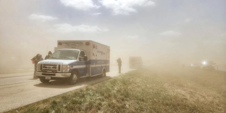 Ambulances and firefighters at the scene of car pileup as a result of a dust storm on I-55 in Illinois on May 1, 2023.