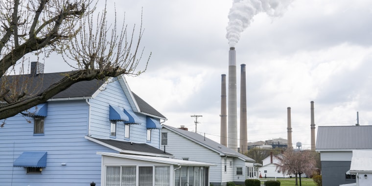 Homes stand in front of a power plant in Conesville, Ohio, in 2020. 