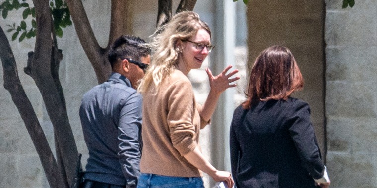 Elizabeth Holmes, founder of Theranos Inc., center, arrives at Federal Prison Camp Bryan in Bryan, Texas, on May 30, 2023.