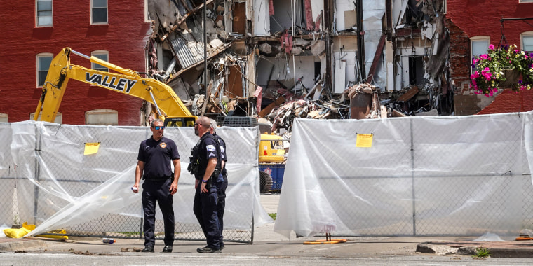 Police continue to secure a six-story apartment building on May 29, 2023, in Davenport, Iowa, after it collapsed the day before.