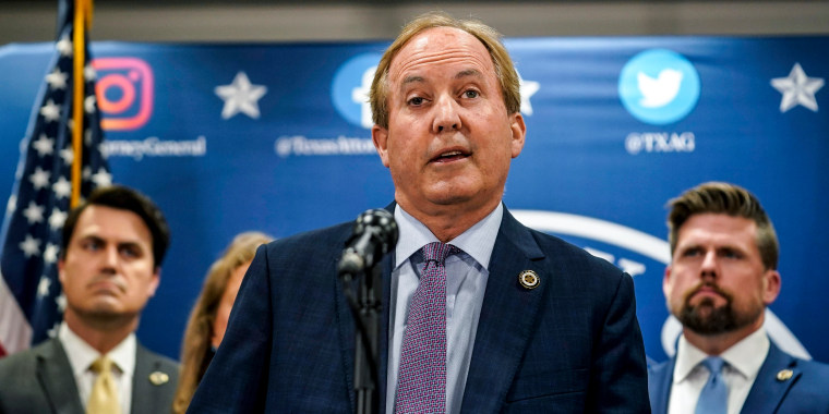Image: Texas state Attorney General Ken Paxton reads a statement at his office in Austin, Texas on May 26, 2023.