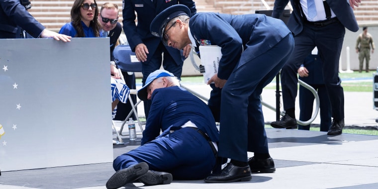 President Joe Biden is helped up after falling during the graduation ceremony