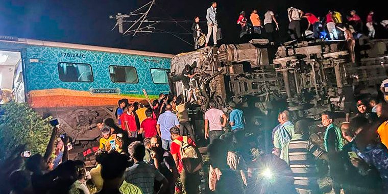 Rescuers work at the site of a train derailed in Balasore district, India