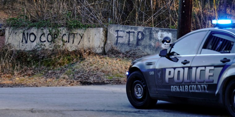 Law enforcement drive past the planned site of a police training facility that activists have nicknamed "Cop City," near Atlanta on Feb. 6, 2023.