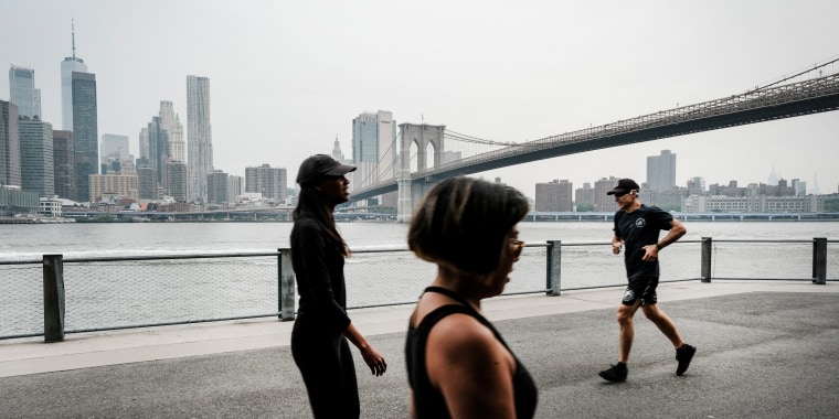Image: People walk through a Brooklyn Park on a hazy morning resulting from Canadian wildfires, on June 6, 2023 in New York .