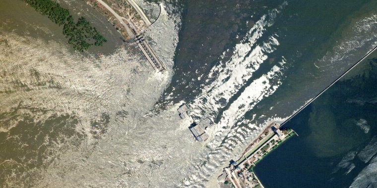 This handout SkySat image taken and released by Planet Labs PBC on June 6, 2023 shows water flowing through the damaged Kakhovka HPP dam in southern Ukraine. The partial destruction on June 6, 2023 of the major Russian-held dam in southern Ukraine unleashed a torrent of water that flooded two dozen villages forcing mass evacuation, sparking fears of a humanitarian disaster near the war's front line. Moscow and Kyiv traded blame for ripping a gaping hole in the Kakhovka dam as expectations built over the start of Ukraine's long-awaited offensive.