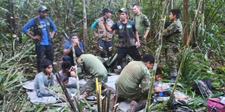 In this photo released by Colombia's Armed Forces Press Office, soldiers and Indigenous men tend to the four Indigenous children who were missing after a deadly plane crash, in the Solano jungle, Caqueta state, Colombia, Friday, June 9, 2023. Colombian President Gustavo Petro said Friday that authorities found alive the four children who survived a small plane crash 40 days ago and had been the subject of an intense search in the Amazon jungle.