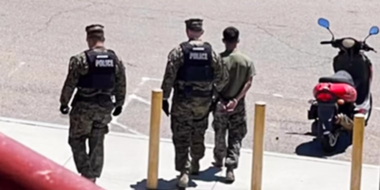 Police take a Marine into custody on June 28, 2023, at Camp Pendleton in Oceanside, Calif., in connection with a teen who was missing for 18 days.
