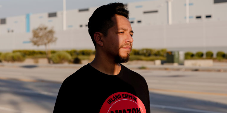 Daniel Rivera poses for a portrait in front of the Amazon warehouse where he works in Highland, Calif.