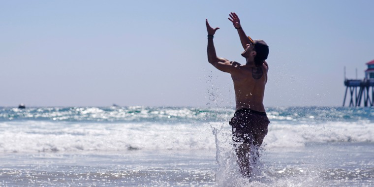 A man catches a flying disc on Aug. 5, 2023, in Huntington Beach, Calif.
