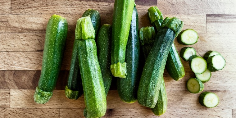 Fresh zucchini on wooden background