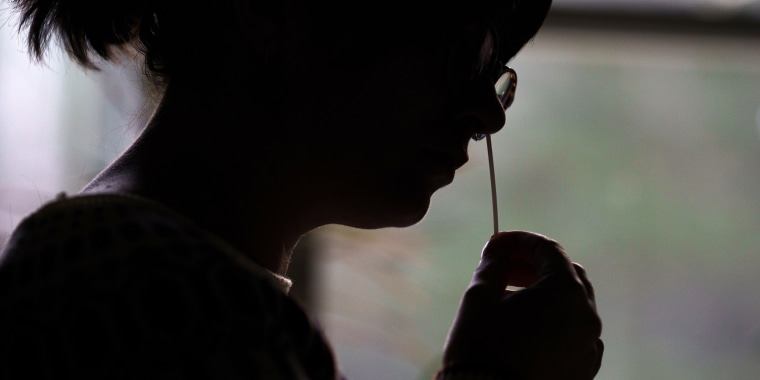 A resident self-administers an at-home Covid-19 test in Easton, N.H, on Dec. 7, 2021.