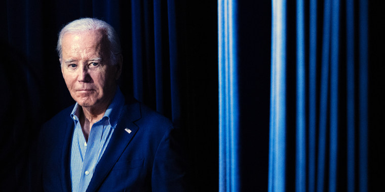 President Joe Biden waits to walk on stage
