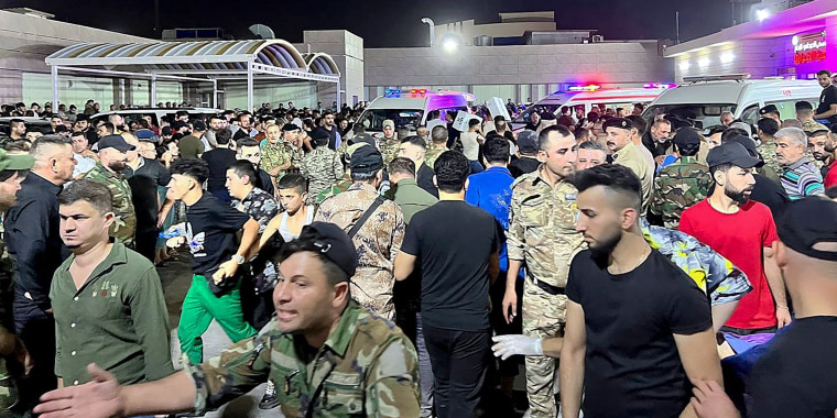 Soldiers and emergency responders among others gather around ambulances carrying wounded people after a fire broke out at a wedding hall during a celebrations, outside the Hamdaniyah general hospital in Bakhdida, Iraq on September 27, 2023. At least 100 people died in Iraq and 150 others were injured in a fire at a wedding in a festival hall in Hamdaniyah, a small town in the northern province of Nineveh, according to health authorities on September 27, 2023.