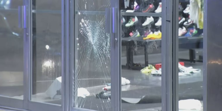 Shattered glass and merchandise on the floor at a Foot Locker Philadelphia that was looted Tuesday, Sept. 26, 2023.