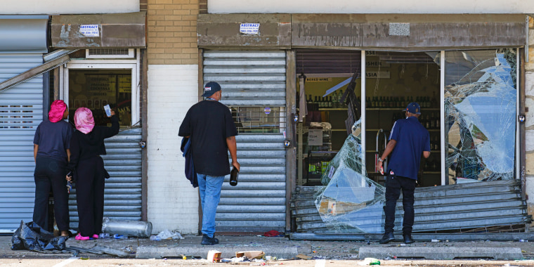 People look at a ransacked liquor store in Philadelphia on Sept. 27, 2023. 