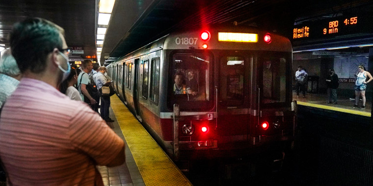 Commuters wait as a Red Line subway train arrives in Boston on July 13, 2022. 