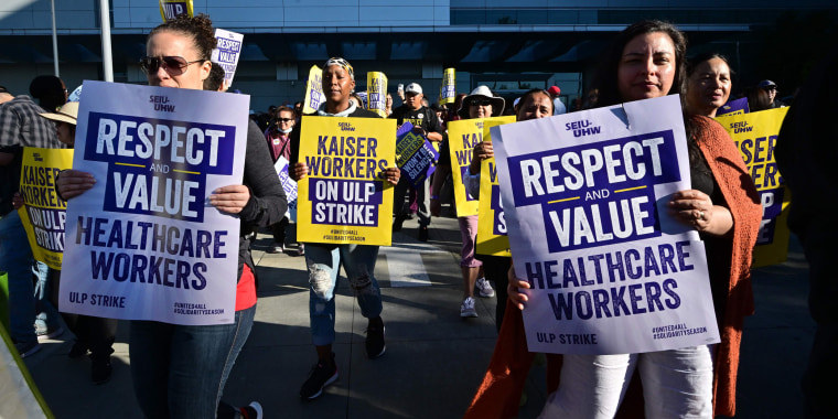 Kaiser Permanente health care employees walk the picket line in Los Angeles