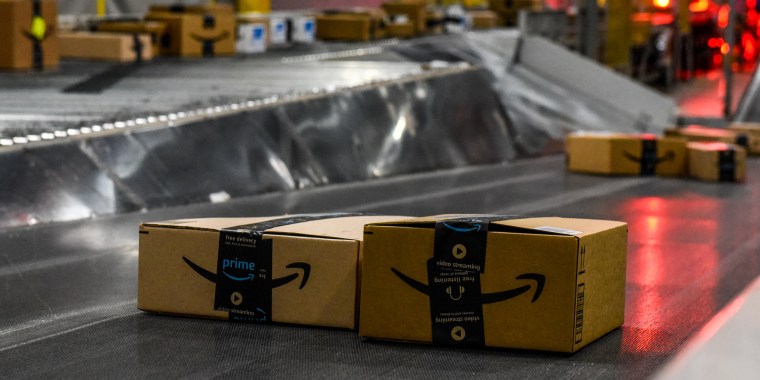 Amazon packages on a conveyor belt.