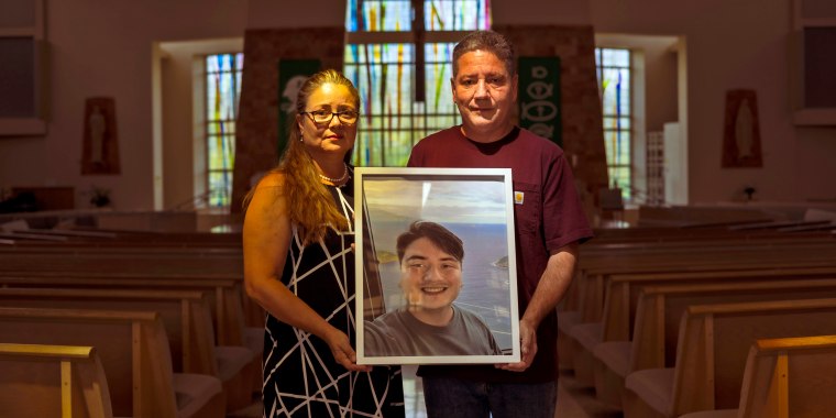 Rosa Elena Martinez and Jaime Mejia hold a photo of their son Sebastian Mejia who died of carbon monoxide poisoning in an Airbnb-rented Rio de Janeiro apartment.