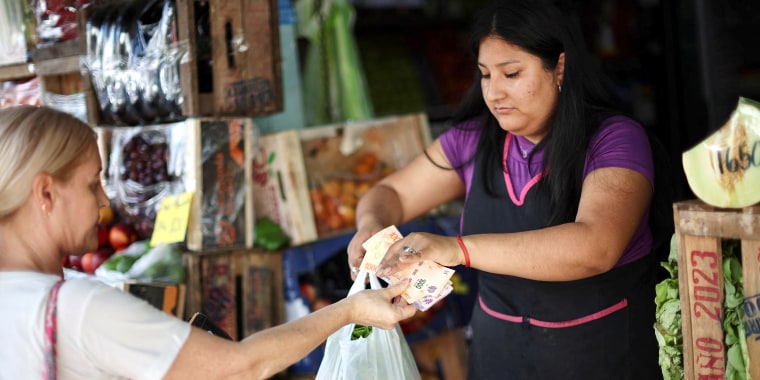 argentina inflation rise shopper grocer purchase food