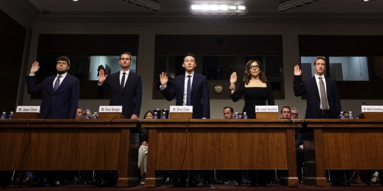 From left, Jason Citron, Evan Spiegel, Shou Zi Chew, Linda Yaccarino, and Mark Zuckerberg are sworn in as they testify before the Senate Judiciary Committee