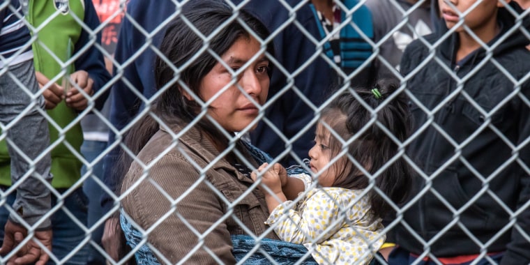 Migrants are gathered inside the fence of a makeshift detention center in El Paso, Texas, on March 27, 2019.