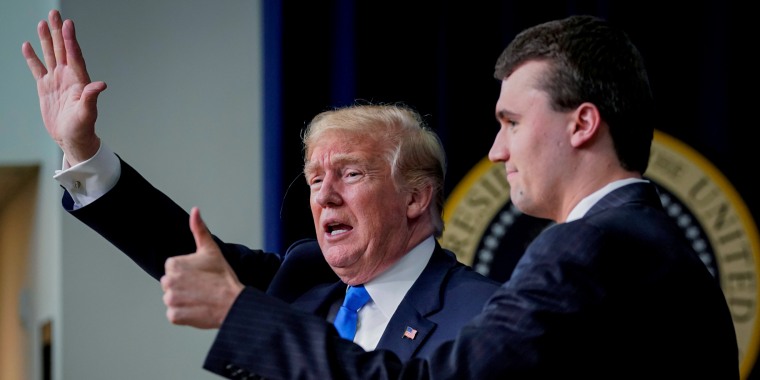 Trump participates in an onstage interview with Charlie Kirk in 2018 at the White House